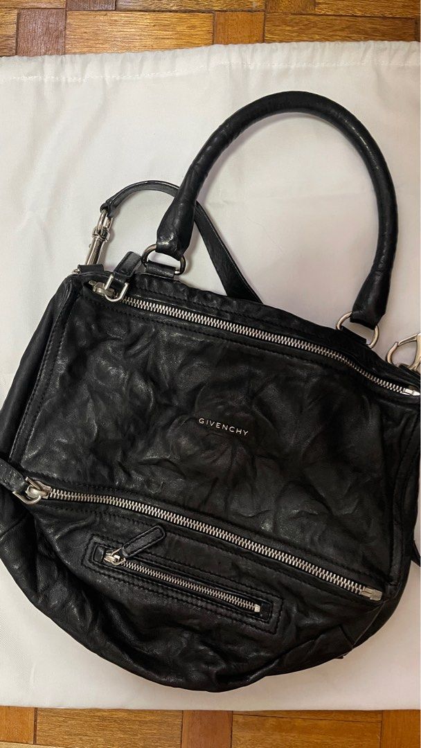 Givenchy Pandora Bag Black Leather (Category: Luxury Bags & Wallets) located in Las Pinas. Submitted by akcessoria.shop (Listing ID 1408291714, Image 1). Description: - Authentic Givenchy Pandora bag - Black leather - Top handle and detachable shoulder strap - Multiple zippered compartments - Silver-tone hardware - Embossed Givenchy logo - Includes dust bag - Perfect for everyday use.