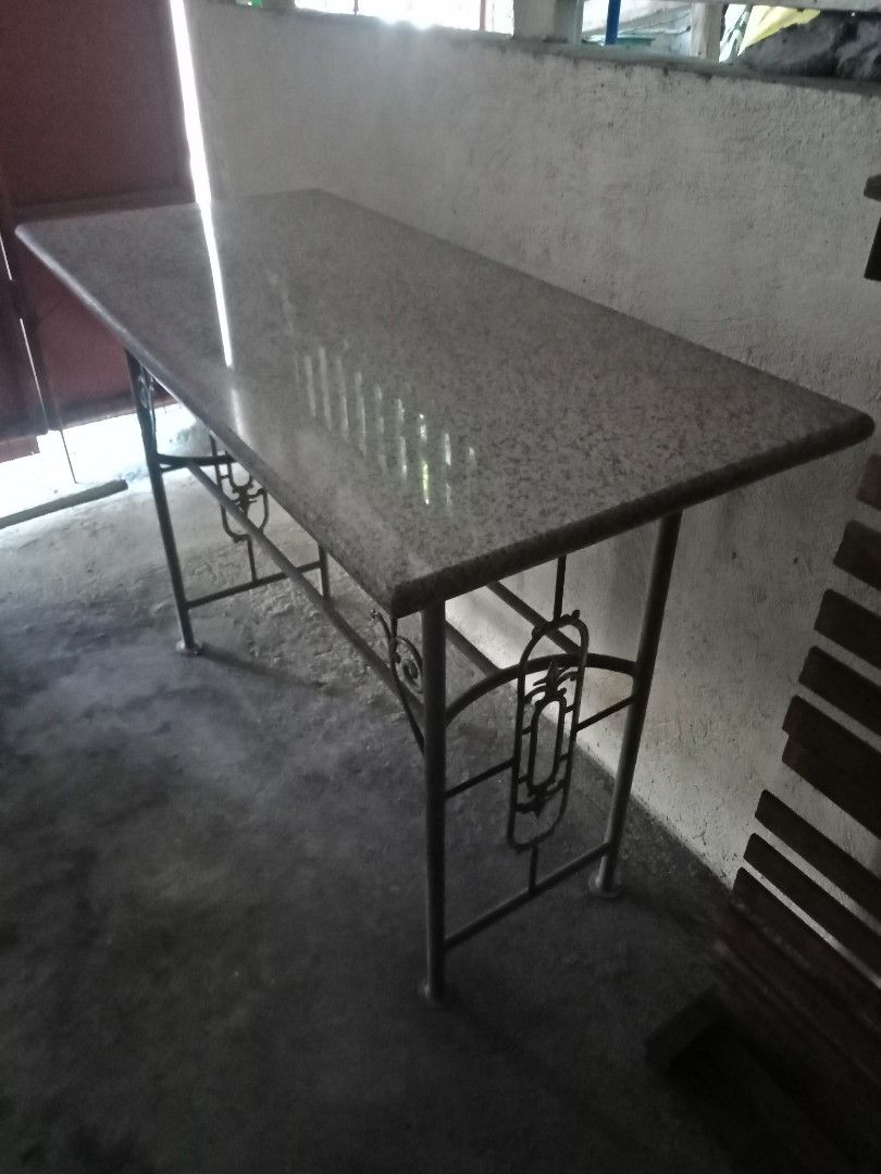 Granite Bar Table (Category: Tables & Sets) located in Taytay. Submitted by rulertrade (Listing ID 1408122159, Image 2). Description: Preloved item Custom-made Real granite stone top (not faux or laminate) Heavy duty Dimension: 2 ft by 4 ft Granite thickness: 2 inches Base stand made of steel pipes Heavy duty Dimension: Height 95 cm Length 111 cm Width 40 cm Granite top is detached from base for easy moving and transport This is also ideal as an 