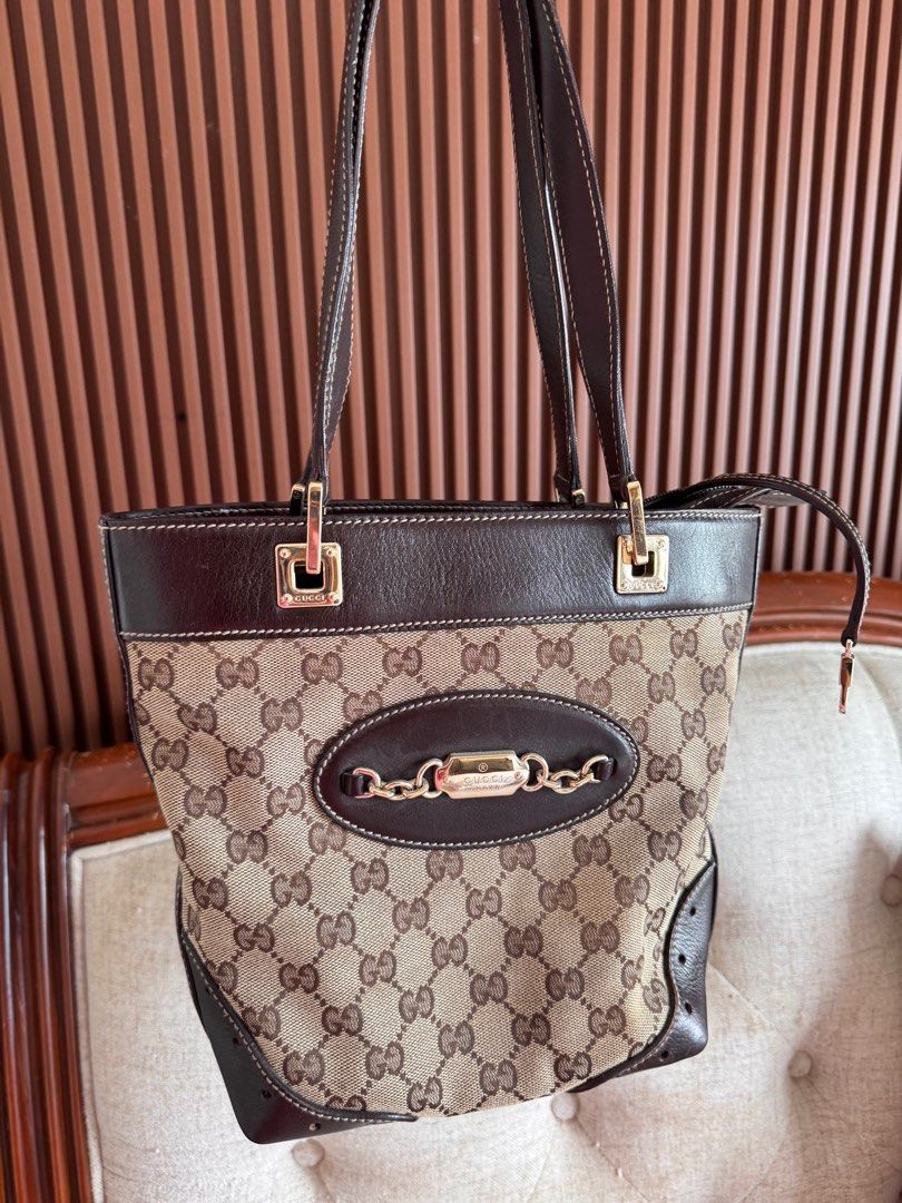 Gucci GG Canvas Tote Bag (Category: Luxury Bags & Wallets) located in Talisay. Submitted by myclosetxoxo. (Listing ID 1408142420, Image 1). Description: - Authentic Gucci tote bag - Iconic GG canvas - Brown leather trim and handles - Gold-tone hardware - Chain detail - Medium size - Classic design - Suitable for everyday use -no return no exchange policy.