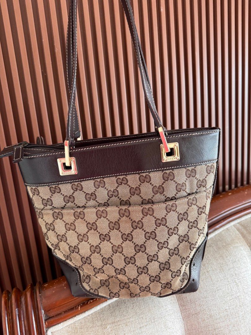Gucci GG Canvas Tote Bag (Category: Luxury Bags & Wallets) located in Talisay. Submitted by myclosetxoxo. (Listing ID 1408142420, Image 3). Description: - Authentic Gucci tote bag - Iconic GG canvas - Brown leather trim and handles - Gold-tone hardware - Chain detail - Medium size - Classic design - Suitable for everyday use -no return no exchange policy.
