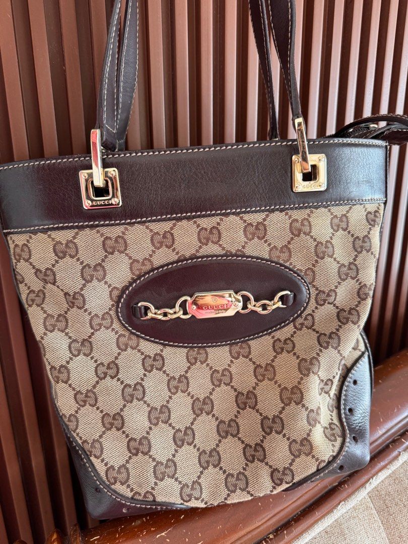 Gucci GG Canvas Tote Bag (Category: Luxury Bags & Wallets) located in Talisay. Submitted by myclosetxoxo. (Listing ID 1408142420, Image 2). Description: - Authentic Gucci tote bag - Iconic GG canvas - Brown leather trim and handles - Gold-tone hardware - Chain detail - Medium size - Classic design - Suitable for everyday use -no return no exchange policy.
