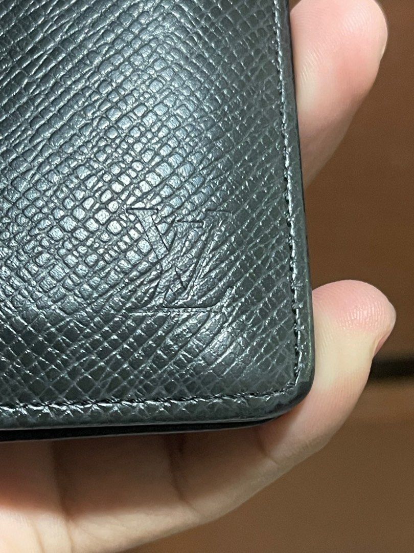 Louis Vuitton Taiga Bifold Wallet (Category: Luxury Bags & Wallets) located in Bacnotan. Submitted by anosellmo (Listing ID 1408125047, Image 2). Description: - Authentic Louis Vuitton wallet - Black exterior with iconic LV logo - Multiple card slots - Features the "Louis Vuitton Paris Made in France" stamp - Date code: CT1004 - Stylish and functional accessory.
