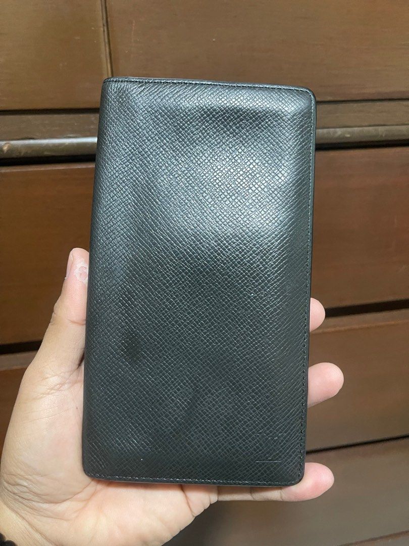 Louis Vuitton Taiga Bifold Wallet (Category: Luxury Bags & Wallets) located in Bacnotan. Submitted by anosellmo (Listing ID 1408125047, Image 1). Description: - Authentic Louis Vuitton wallet - Black exterior with iconic LV logo - Multiple card slots - Features the "Louis Vuitton Paris Made in France" stamp - Date code: CT1004 - Stylish and functional accessory.