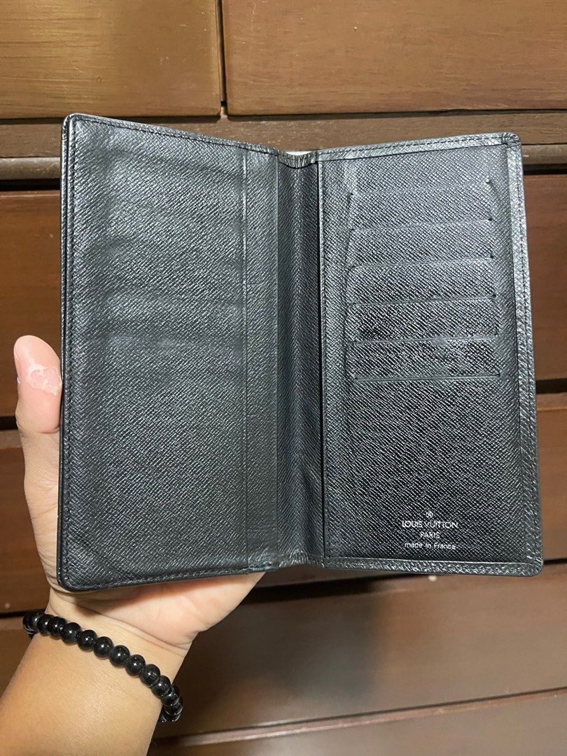 Louis Vuitton Taiga Bifold Wallet (Category: Luxury Bags & Wallets) located in Bacnotan. Submitted by anosellmo (Listing ID 1408125047, Image 3). Description: - Authentic Louis Vuitton wallet - Black exterior with iconic LV logo - Multiple card slots - Features the "Louis Vuitton Paris Made in France" stamp - Date code: CT1004 - Stylish and functional accessory.