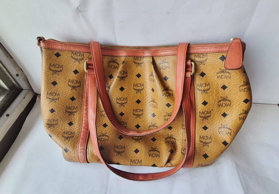 MCM 2 way bag Authentic (Category: Luxury Bags & Wallets) located in Caloocan City. Submitted by celonessentials (Listing ID 1408141541, Image 3). Description: Authentic MCM bag no more strap with signs of use on leather, see last pics bag is roomy and leather is so nice size: H10"x W13" x D6" code: Z6823.