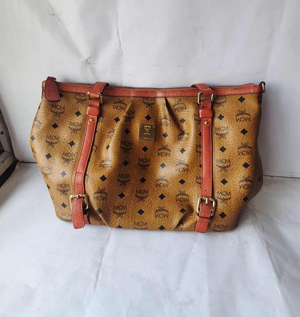 MCM 2 way bag Authentic (Category: Luxury Bags & Wallets) located in Caloocan City. Submitted by celonessentials (Listing ID 1408141541, Image 1). Description: Authentic MCM bag no more strap with signs of use on leather, see last pics bag is roomy and leather is so nice size: H10"x W13" x D6" code: Z6823.
