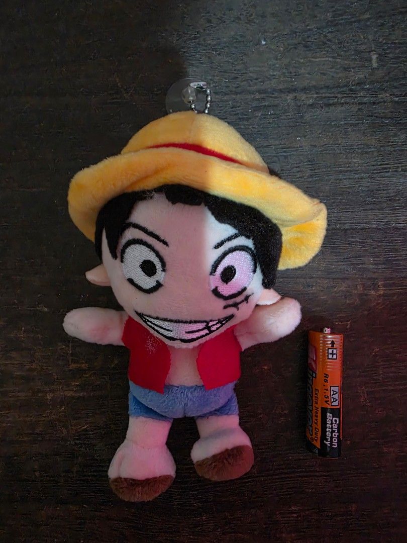 One Piece Luffy Plush Keychain (Category: Plushies & Soft Toys) located in Tanauan. Submitted by jcang5 (Listing ID 1408169270, Image 1). Description: Luffy plush keychain from the anime series One Piece. It features Luffy wearing his signature straw hat and red shirt. The plush has a keychain attachment, making it easy to hang on bags or keys. It is a cute and collectible item for any One Piece fan..