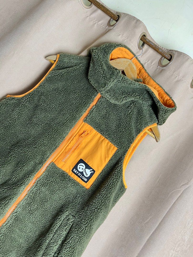 RAH! Reversible Vest (Category: Vests) located in Cebu City. Submitted by klvnthrifts (Listing ID 1408146143, Image 2). Description: - RAH! Reversible Vest - Exterior: Green fleece with orange pocket and trim, "Say It Loud" patch - Interior: Yellow with "Peace Love Laugh" print - Features: Hood, zipper closure - Size: M / 160/80A.
