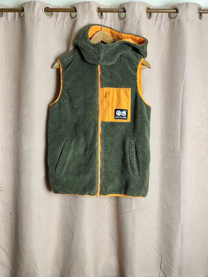 RAH! Reversible Vest (Category: Vests) located in Cebu City. Submitted by klvnthrifts (Listing ID 1408146143, Image 1). Description: - RAH! Reversible Vest - Exterior: Green fleece with orange pocket and trim, "Say It Loud" patch - Interior: Yellow with "Peace Love Laugh" print - Features: Hood, zipper closure - Size: M / 160/80A.