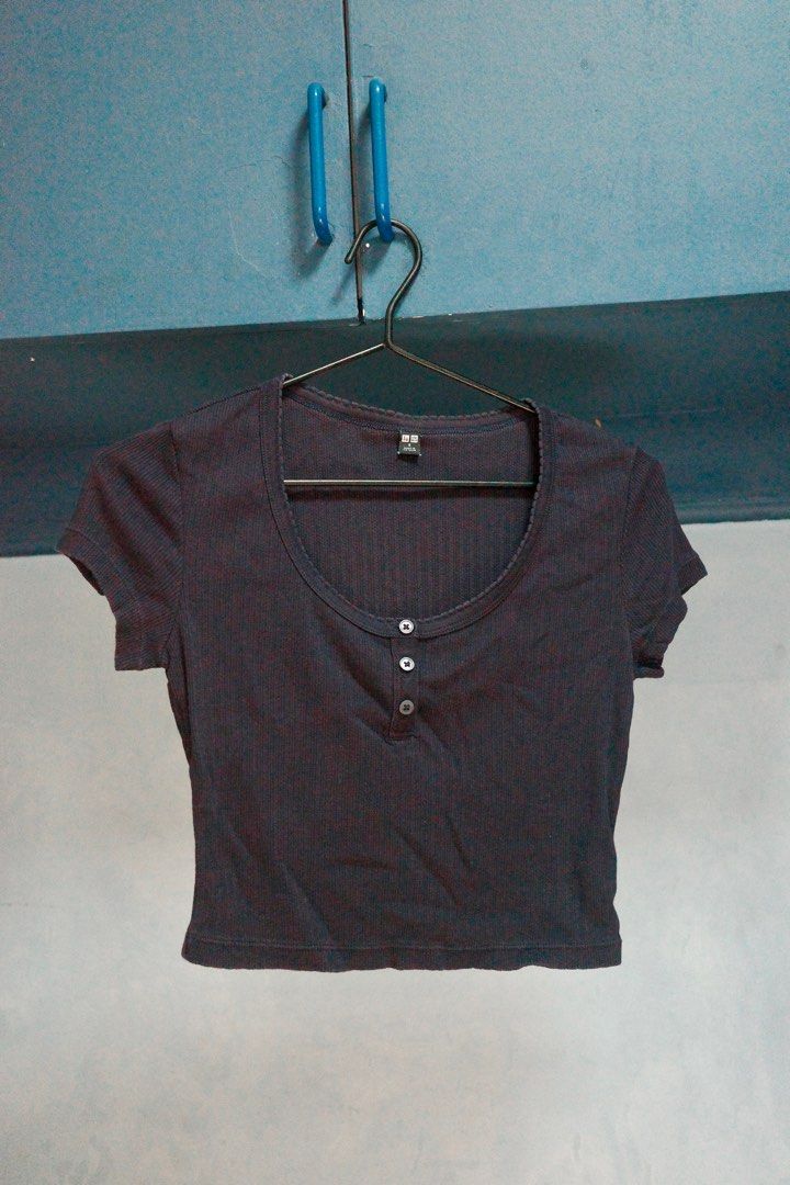 Uniqlo Ribbed Crop Top - Size S (Category: Shirts) located in Quezon City. Submitted by kitkat0328 (Listing ID 1408182461, Image 1). Description: - Uniqlo Ribbed Crop Top - Color: Navy blue - Features: Scoop neckline, button-up front - Sleeves: Short - Fit: Fitted, cropped silhouette - Size: S - Made in Vietnam.