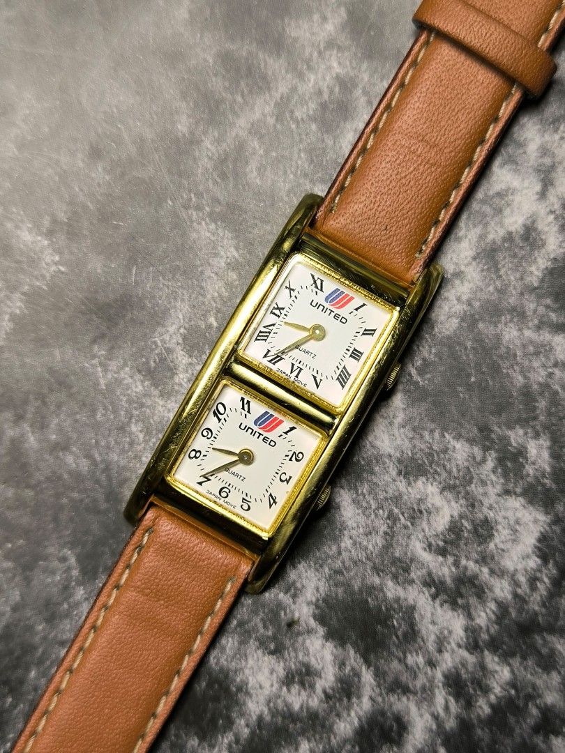 United Dual Time Watch (Category: Women's Watches) located in Pasay City. Submitted by cassiuss (Listing ID 1408144689, Image 1). Description: - United dual-time watch - Rectangular gold-toned case - Brown leather strap ( a bit worn out) - Dual time display - Roman and standard numerals on watch face.