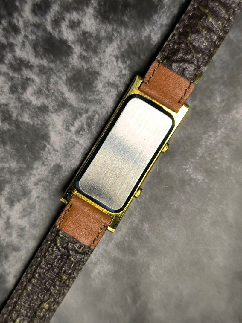 United Dual Time Watch (Category: Women's Watches) located in Pasay City. Submitted by cassiuss (Listing ID 1408144689, Image 2). Description: - United dual-time watch - Rectangular gold-toned case - Brown leather strap ( a bit worn out) - Dual time display - Roman and standard numerals on watch face.