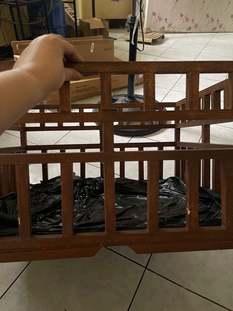 Wooden Crate (Category: Storage Boxes & Baskets) located in Marikina City. Submitted by leahkatrin46536 (Listing ID 1408215527, Image 2). Description: Wooden crate is perfect for storage or display. It features a sturdy wooden frame with a square shape. The crate has a dark brown color and a grid-like design. A black plastic sheet is placed inside the crate. It is suitable for various uses, adding a rustic touch to any space..