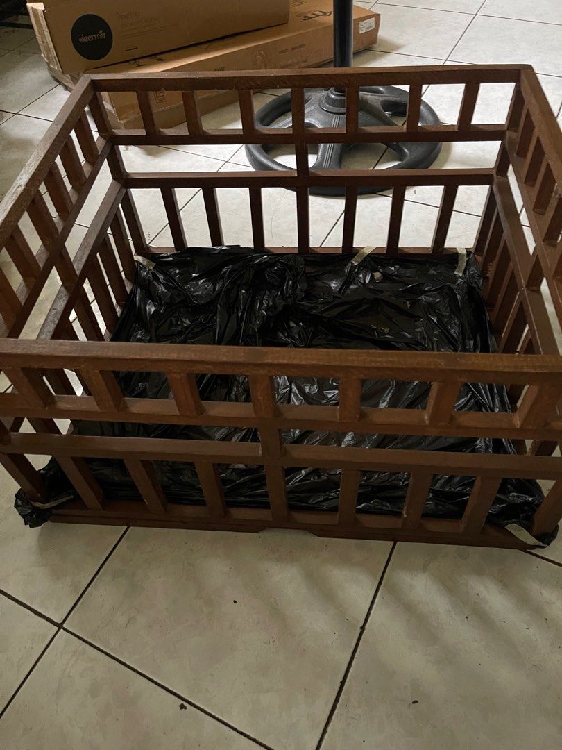 Wooden Crate (Category: Storage Boxes & Baskets) located in Marikina City. Submitted by leahkatrin46536 (Listing ID 1408215527, Image 3). Description: Wooden crate is perfect for storage or display. It features a sturdy wooden frame with a square shape. The crate has a dark brown color and a grid-like design. A black plastic sheet is placed inside the crate. It is suitable for various uses, adding a rustic touch to any space..