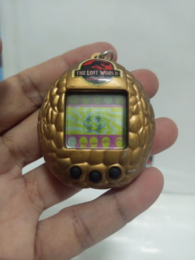 1997 Jurassic Park Lost World Vitual Pet Game (Category: Action & Battle Toys) located in Quezon City. Submitted by mackylolz (Listing ID 1408332248, Image 1). Description: 1997 Jurassic Park Lost World Vitual Pet Game Working and Tested 2pcs LR44 Battery (Not included) Have some Minimal Paint chip What you See is what u Get Pls See pic for Details.