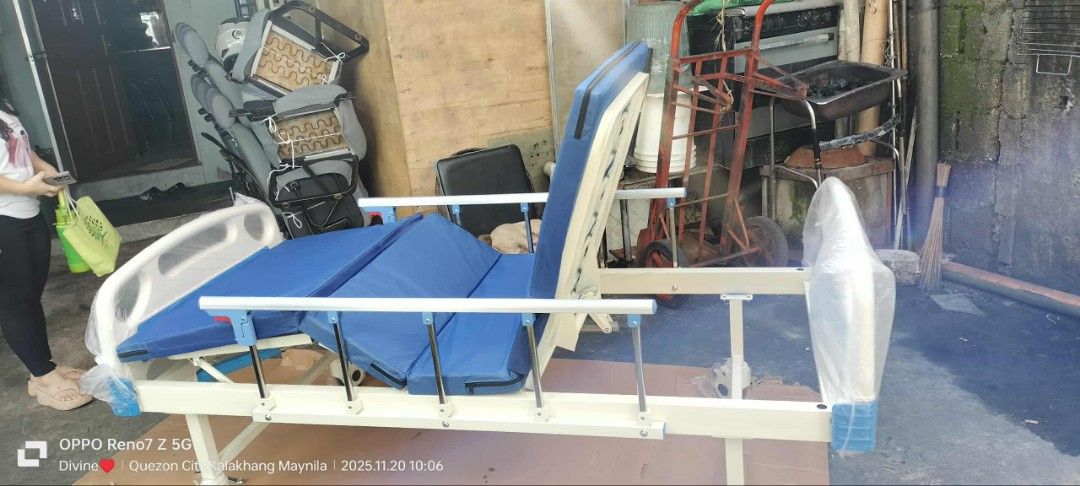 Adjustable Hospital Bed with Mattress (Category: Bed Frames & Mattresses) located in Quezon City. Submitted by gentlewater_b4735d (Listing ID 1408492376, Image 3). Description: - Adjustable hospital bed - Blue mattress - Features side rails - Adjustable head and foot sections - Includes crank mechanism - Suitable for home or clinical use.