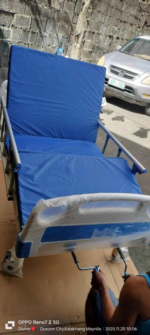 Adjustable Hospital Bed with Mattress (Category: Bed Frames & Mattresses) located in Quezon City. Submitted by gentlewater_b4735d (Listing ID 1408492376, Image 1). Description: - Adjustable hospital bed - Blue mattress - Features side rails - Adjustable head and foot sections - Includes crank mechanism - Suitable for home or clinical use.