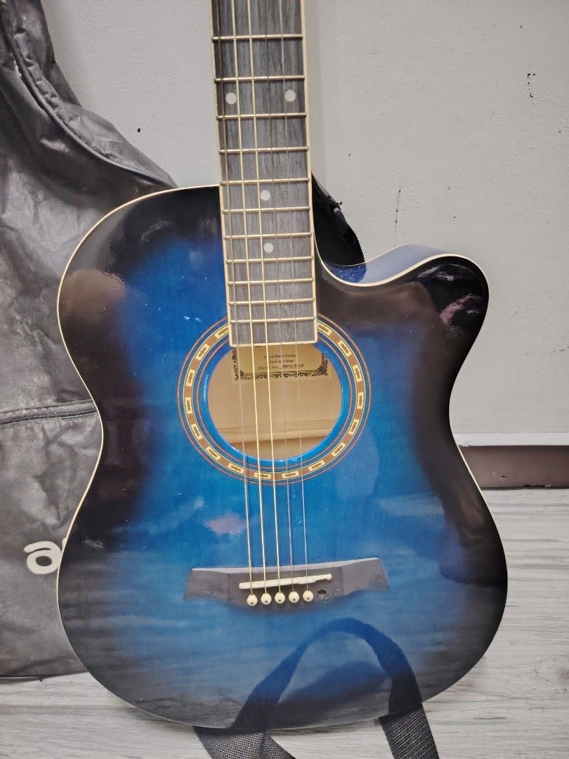 Arena Acoustic Guitar with Case (Category: Musical Instruments) located in Navotas City. Submitted by focalpoint2782 (Listing ID 1408437758, Image 2). Description: Arena acoustic guitar features a striking blue finish. It comes with a carrying case and a guitar capo. The guitar has six strings and a standard ex fretboard. The Arena logo is visible on the headstock. Mop : cash or gcash payments Location : Navotas City Currier : lalamove and grab.