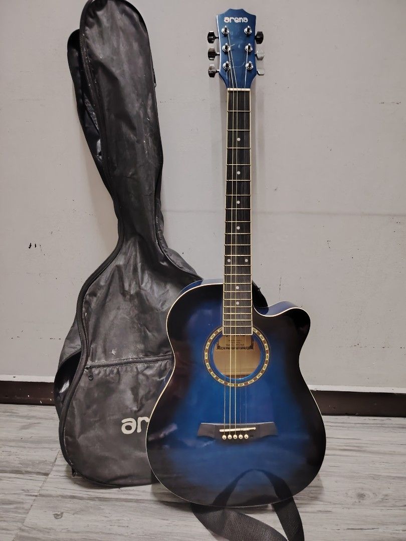 Arena Acoustic Guitar with Case (Category: Musical Instruments) located in Navotas City. Submitted by focalpoint2782 (Listing ID 1408437758, Image 1). Description: Arena acoustic guitar features a striking blue finish. It comes with a carrying case and a guitar capo. The guitar has six strings and a standard ex fretboard. The Arena logo is visible on the headstock. Mop : cash or gcash payments Location : Navotas City Currier : lalamove and grab.