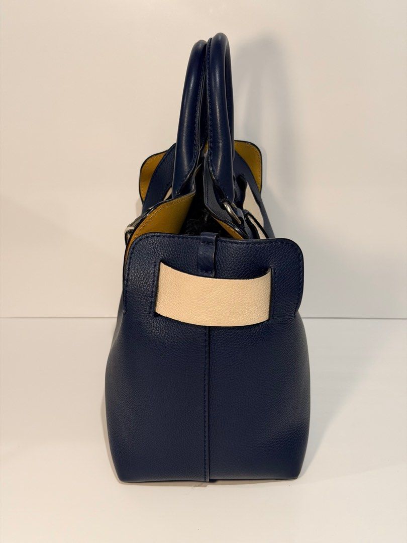 Burberry Belt Bag (Category: Luxury Bags & Wallets) located in Olongapo. Submitted by howietv (Listing ID 1408380496, Image 3). Description: - Authentic Burberry handbag - Navy blue exterior with cream belt detail - Detachable shoulder strap - Yellow interior lining - Multiple pockets - Top handle - Silver hardware - Includes certificate of authenticity.