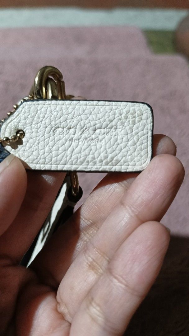 Coach Signature Denim Handbag (Category: Luxury Bags & Wallets) located in Goa. Submitted by kaye_dee (Listing ID 1408326271, Image 3). Description: - Denim signature pattern - White leather handle and accents - Zip closure - Gold-tone hardware - Includes Coach tag - Small attached tag - Navy blue leather bottom - Coach logo patch -Coach Dempsey Shoulder Bag In Signature Jacquard With Patch..