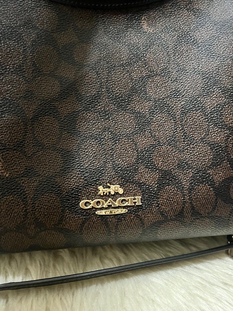 Coach Signature Shoulder Bag (Category: Luxury Bags & Wallets) located in Caloocan City. Submitted by ericavi_g (Listing ID 1408490143, Image 3). Description: - Coach shoulder bag - Signature brown print - Top handle and detachable shoulder strap - Interior zippered pocket - Coach leather tag - Gold-tone hardware - Classic Coach design.