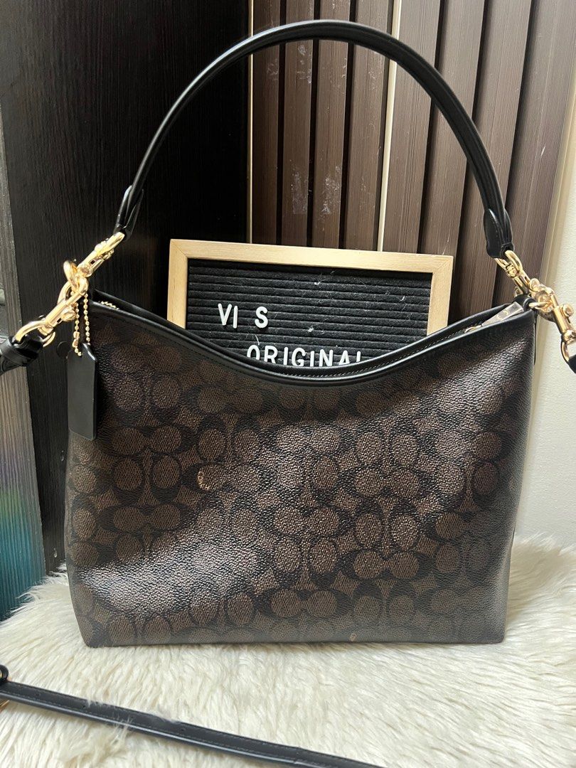 Coach Signature Shoulder Bag (Category: Luxury Bags & Wallets) located in Caloocan City. Submitted by ericavi_g (Listing ID 1408490143, Image 2). Description: - Coach shoulder bag - Signature brown print - Top handle and detachable shoulder strap - Interior zippered pocket - Coach leather tag - Gold-tone hardware - Classic Coach design.