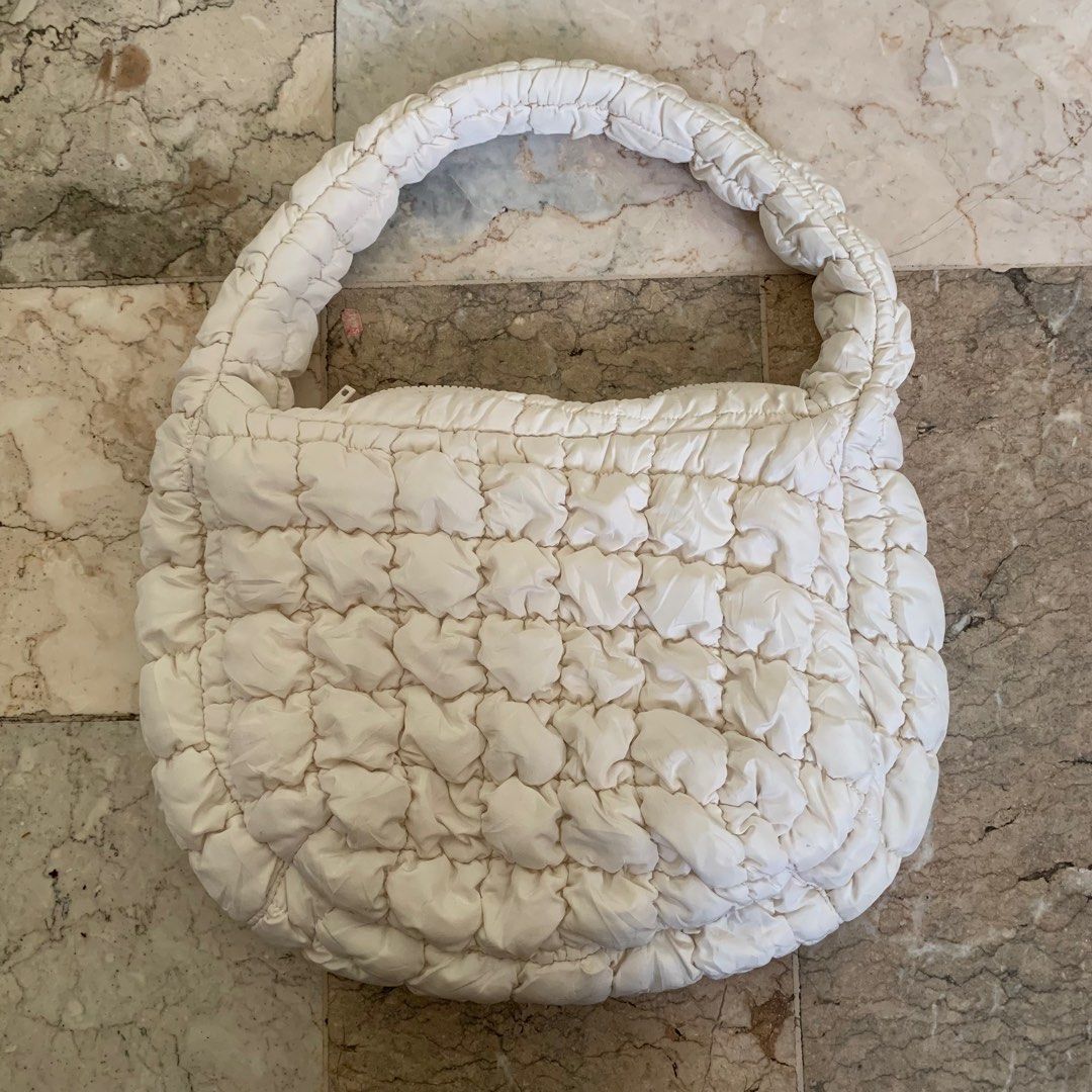 COS Mini Quilted Handbag / cloud bag/ puffer bag (Category: Luxury Bags & Wallets) located in Tarlac. Submitted by closetcleanupsale.ph (Listing ID 1408372860, Image 1). Description: Authentic COS Quilted Handbag Elegant off white design Soft, padded material Top handle for easy carrying Secure zip closure Spacious interior for your essentials No stains, no rips used few times then stored nicer in actual when the bag is already full LP POSTED.