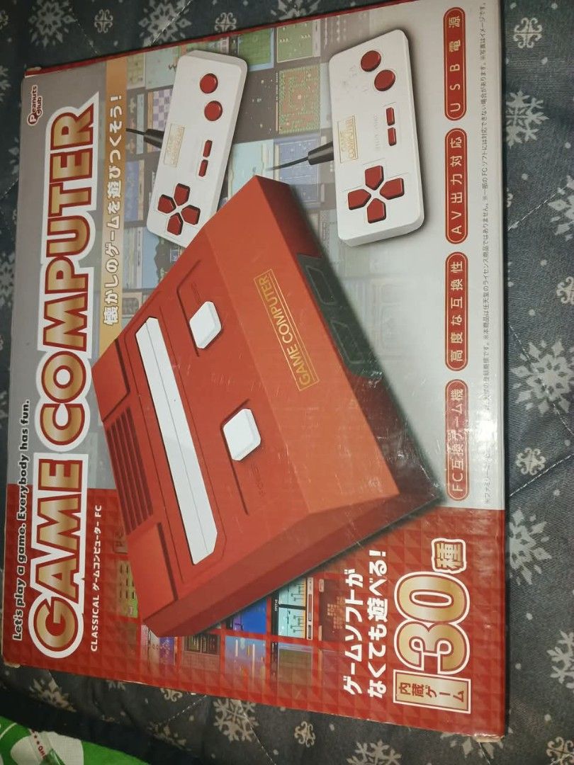 Game Computer Retro Console with 130 Games (Category: Others) located in Caloocan City. Submitted by youngdog_7a3ee7 (Listing ID 1408321945, Image 2). Description: Retro game console comes with 130 built-in games. It includes the console, two controllers, and AV cables. The console has a red and white color scheme. It supports AV output and USB charging. Enjoy classic games with this console!.