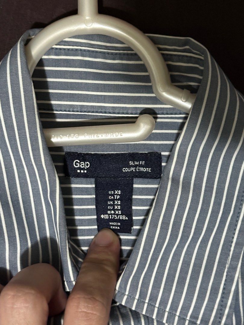 Gap Slim Fit Striped Shirt (Category: Tshirts & Polo Shirts ) located in Manila. Submitted by p2129_ (Listing ID 1408319820, Image 3). Description: Gap buttondown longsleeves Blue with white stripes No stains Complete buttons #gap #uniqlo #h&m #zara #longsleeves.