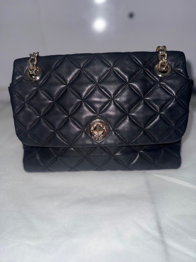 Kate Spade Black Quilted Shoulder Bag (Category: Luxury Bags & Wallets) located in Manila. Submitted by boldshark-6592 (Listing ID 1408398175, Image 1). Description: - Kate Spade shoulder bag - Black quilted design - Chain strap with leather accents - Flap closure with decorative clasp - Leather material - Diamond pattern.
