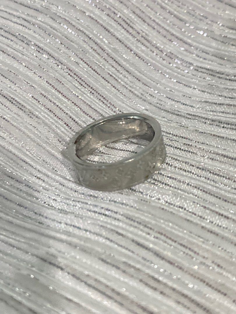 Louis Vuitton Monogram Ring (Size 5-6) (Category: Rings) located in Tiwi. Submitted by camila_dp (Listing ID 1408416834, Image 3). Description: - Vintage Louis Vuitton design - Features the iconic monogram pattern - Silver-colored metal - Band style ring - Engraved with LV logo and monogram flowers - Simple and elegant design.