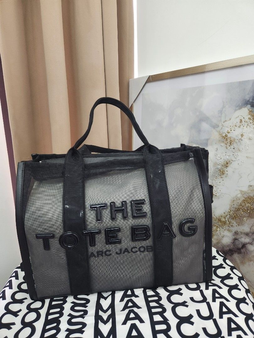Authentic Marc Jacobs The Tote Bag (Category: Luxury Bags & Wallets) located in Quezon City. Submitted by simpleshaine04 (Listing ID 1408334908, Image 1). Description: - Authentic Limited Edition Marc Jacobs The Tote Bag - Black mesh design - Features brand name display - Includes detachable pouch - Comes with original tags - Includes Marc Jacobs paper bag - Ideal for everyday use - Stylish accessory.