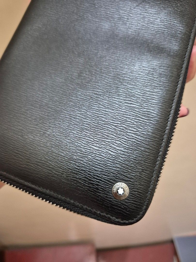 Montblanc Black Leather Zip Around Wallet (Category: Luxury Bags & Wallets) located in Pasig City. Submitted by 53888 (Listing ID 1408477469, Image 2). Description: - Authentic Montblanc wallet coded - Black leather zip-around design - Multiple card slots - Zippered compartment for coins or small items - Bill compartment - Silver-toned zipper and hardware - Montblanc logo visible inside and out - Made with high-quality leather .