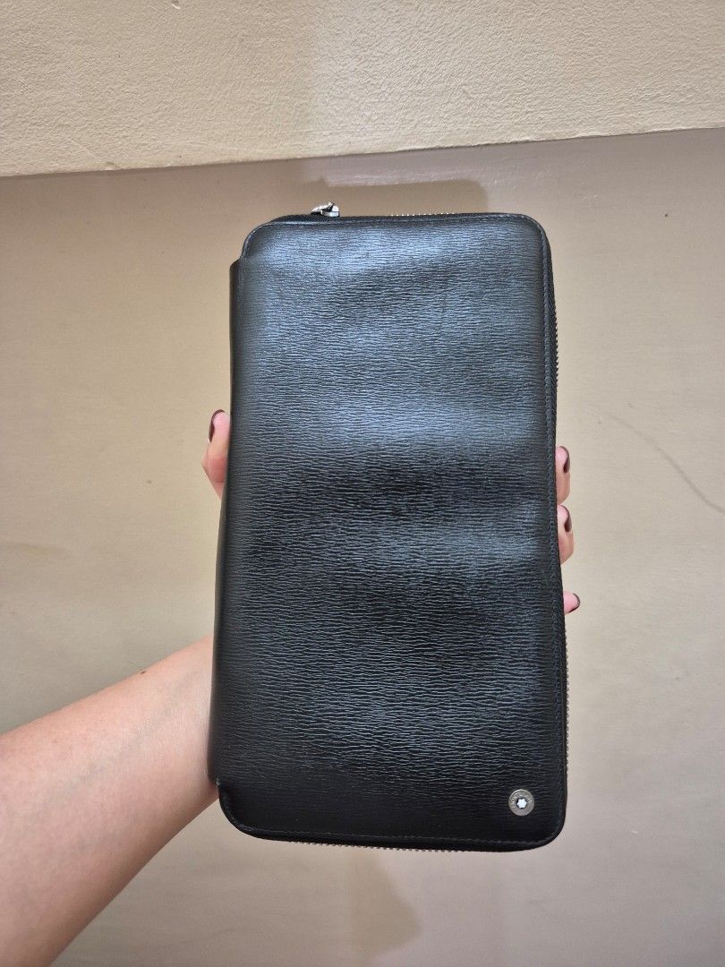 Montblanc Black Leather Zip Around Wallet (Category: Luxury Bags & Wallets) located in Pasig City. Submitted by 53888 (Listing ID 1408477469, Image 1). Description: - Authentic Montblanc wallet coded - Black leather zip-around design - Multiple card slots - Zippered compartment for coins or small items - Bill compartment - Silver-toned zipper and hardware - Montblanc logo visible inside and out - Made with high-quality leather .