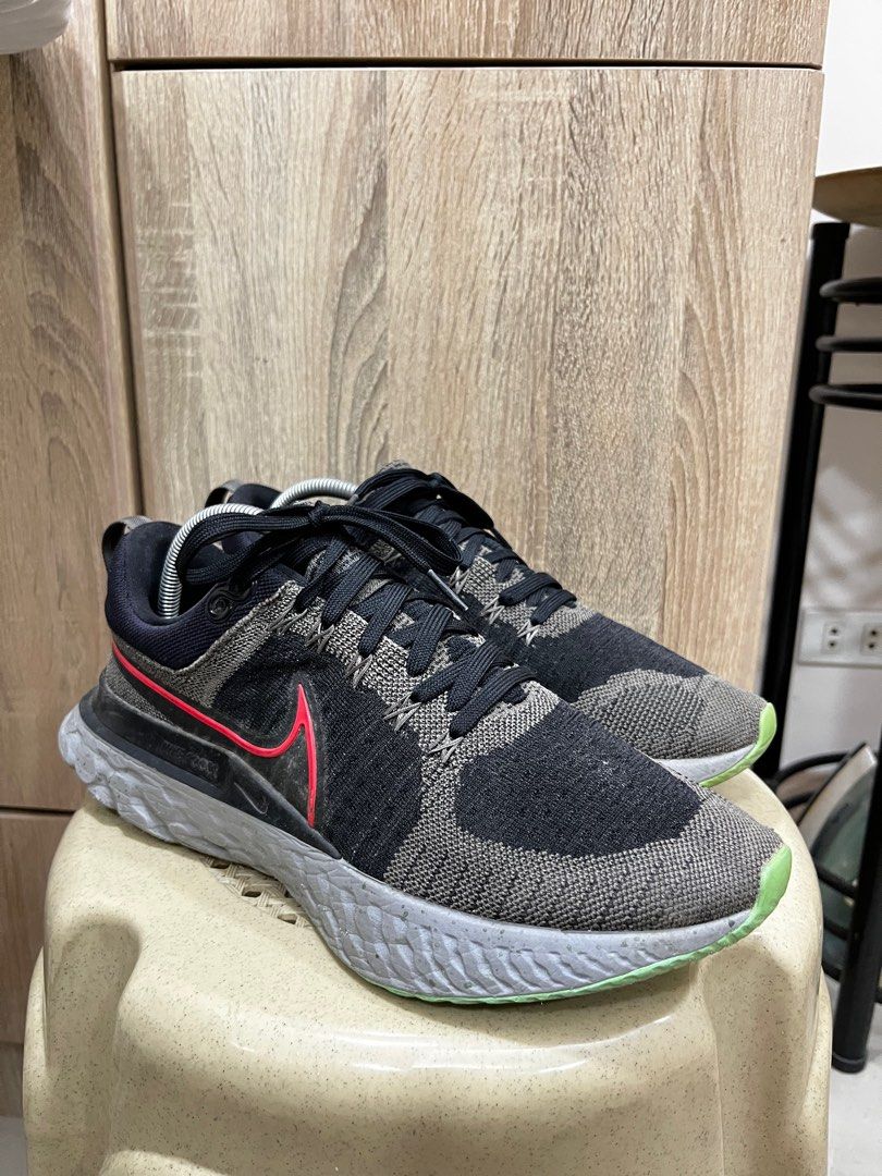 Nike React Infinity Run Flyknit 2 (Category: Sneakers) located in Manila. Submitted by gojosells (Listing ID 1408483416, Image 1). Description: - Nike React Infinity Run Flyknit 2 sneakers - Color: Black and grey - Features a red Nike swoosh - Sole: Green and grey - Size: US 10, UK 9, EUR 44, CM 28 - Black laces and grey midsole - Condition: Excellent -No Box.