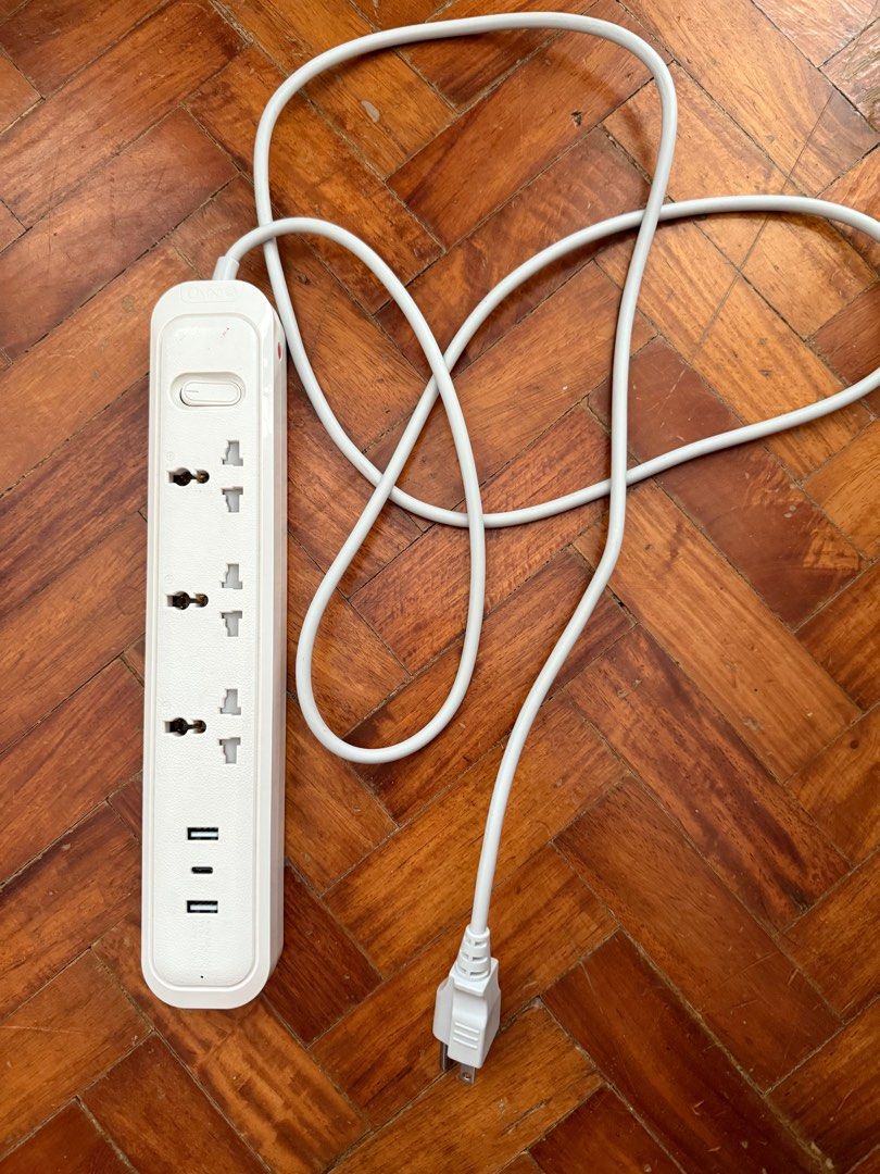 OMNI White Power Strip with USB Ports (Category: Lighting) located in Makati City. Submitted by freetree-deed (Listing ID 1408448162, Image 1). Description: White power strip features multiple universal outlets and two USB ports. It has an on/off switch and a long white power cord. The design is sleek and modern, suitable for various electronic devices. .