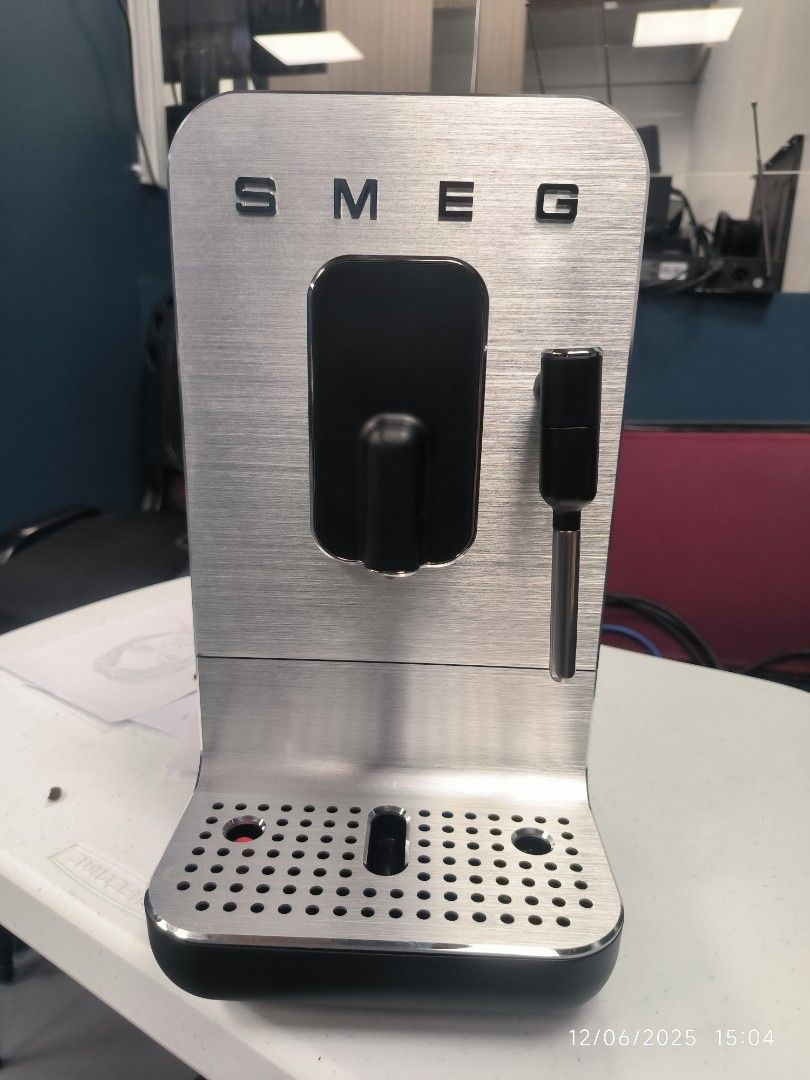 Smeg Espresso Machine (Category: Coffee Machines & Makers) located in Pulilan. Submitted by srtidon (Listing ID 1408324797, Image 1). Description: - Smeg espresso machine BCC 12 - Sleek design with stainless steel front and black body - Features a steam wand - Includes a drip tray - Comes with original packaging and manual.