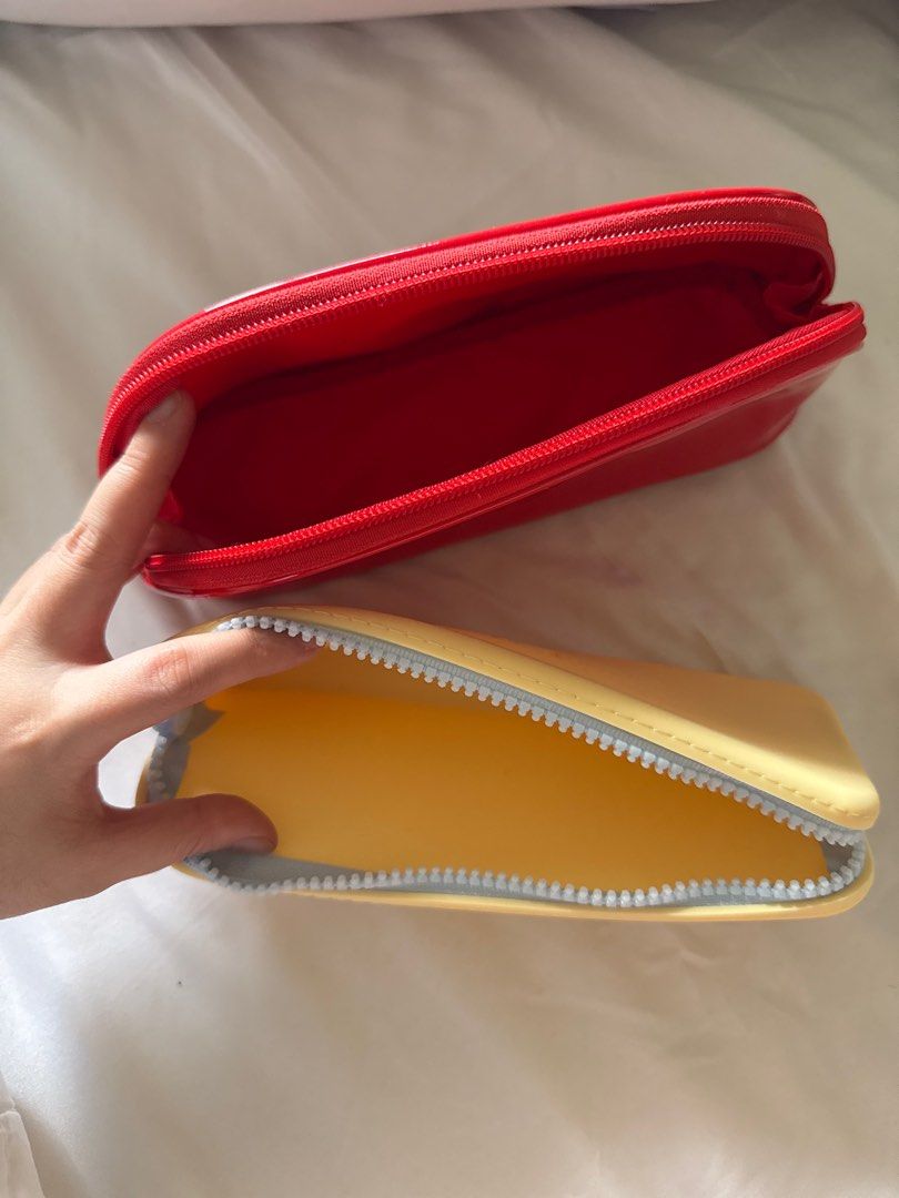Sunnies Face Jelly Red & BLK Silicone Pouch Set (Category: Purses & Pouches) located in Pasig City. Submitted by prelovedjeeems (Listing ID 1408319465, Image 2). Description: - Set Price: P600 ONLY!!! - Great for gifts this xmas! - Sunnies Face Trapezoid Pouch in ruby / Original Price: P 816 - BLK Silicone Pouch in yellow / Original Price: P230 RFS: Decluttering Mode of payment: BDO, Gcash, COD with additional fee from couriers Delivery: lalamove