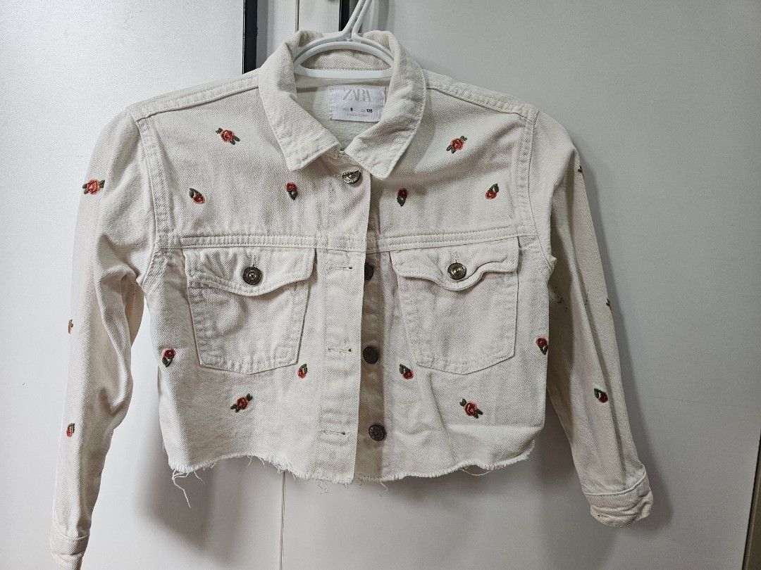 Zara Embroidered Denim Jacket - Size 8 (Category: Coats, Jackets and Outerwear) located in Mandaluyong City. Submitted by blueberrypatch (Listing ID 1408343371, Image 1). Description: - Zara denim jacket for girls - Size 8 (128cm) - Cream color - Embroidered with red flower details - Two front pockets - Button closures - Made in Turkey.