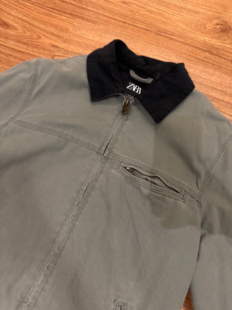 Zara Workwear Jacket (Category: Coats, Jackets and Outerwear) located in Paranaque City. Submitted by declutterhead (Listing ID 1408479302, Image 2). Description: - Negotiable - Zara workwear jacket - Black collar - Zip closure - Multiple pockets - Small logo patch - Durable material - Solid color (green or grey).
