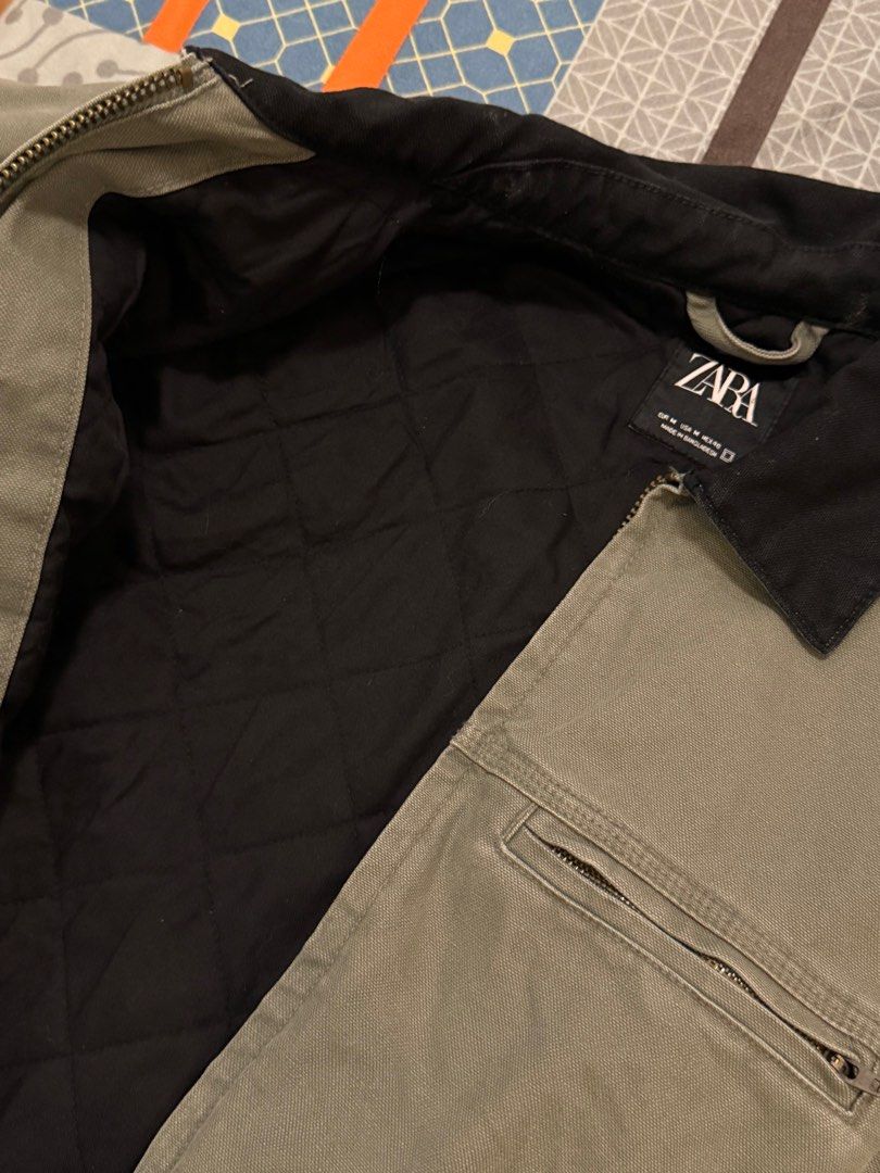 Zara Workwear Jacket (Category: Coats, Jackets and Outerwear) located in Paranaque City. Submitted by declutterhead (Listing ID 1408479302, Image 3). Description: - Negotiable - Zara workwear jacket - Black collar - Zip closure - Multiple pockets - Small logo patch - Durable material - Solid color (green or grey).