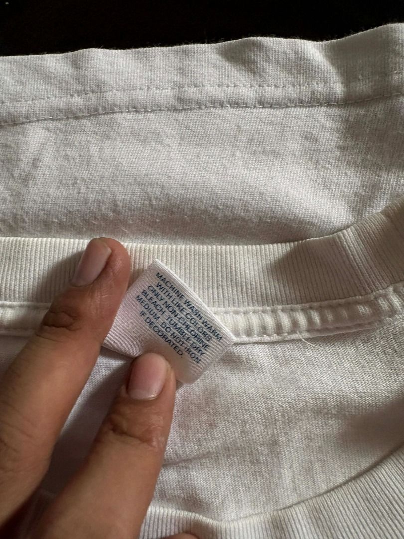 ( Authentic ) Supreme iconic box logo tee (Category: Tshirts & Polo Shirts ) located in Quezon City. Submitted by mr.mclovin (Listing ID 1408539489, Image 2). Description: White Supreme Box Logo T-shirt. Features the iconic red box logo on the chest. The tag is visible at the neckline. The shirt is folded..