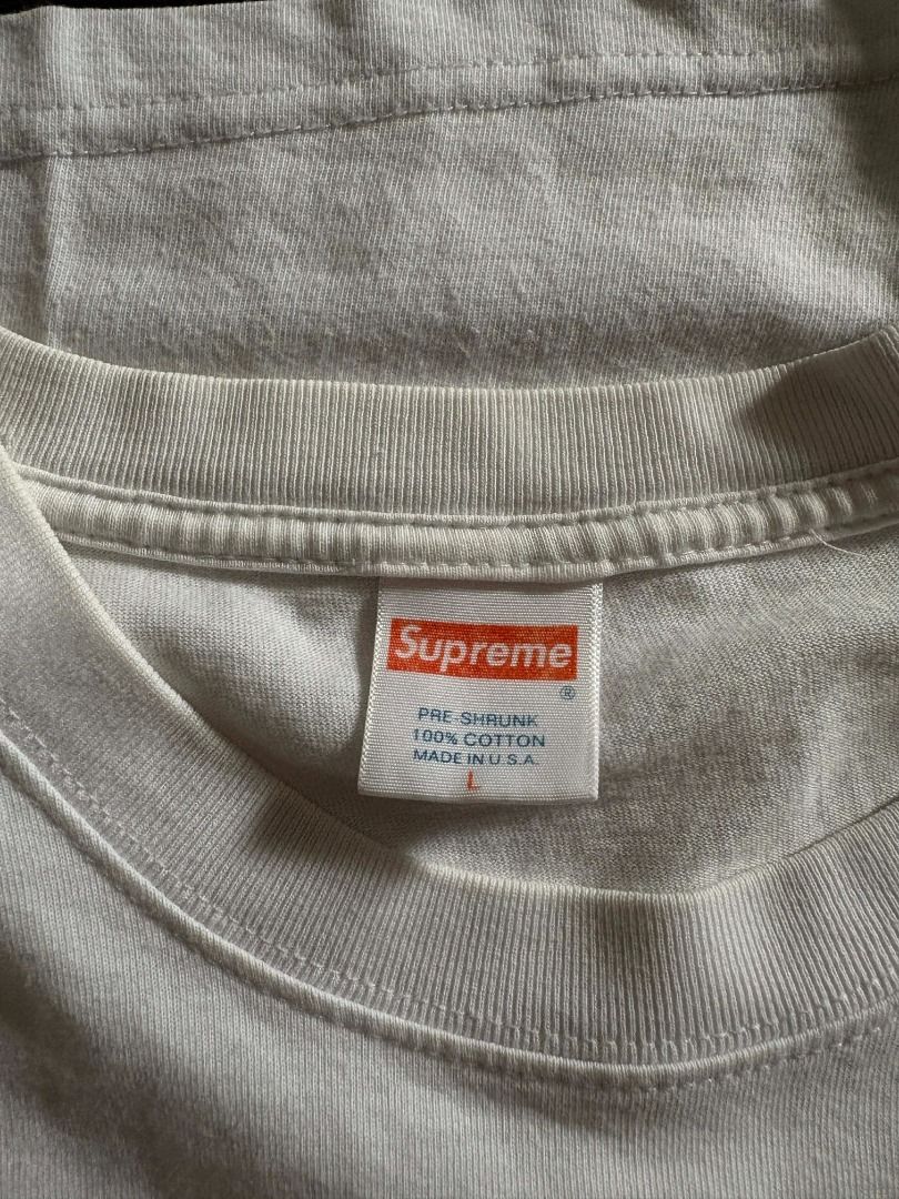 ( Authentic ) Supreme iconic box logo tee (Category: Tshirts & Polo Shirts ) located in Quezon City. Submitted by mr.mclovin (Listing ID 1408539489, Image 3). Description: White Supreme Box Logo T-shirt. Features the iconic red box logo on the chest. The tag is visible at the neckline. The shirt is folded..