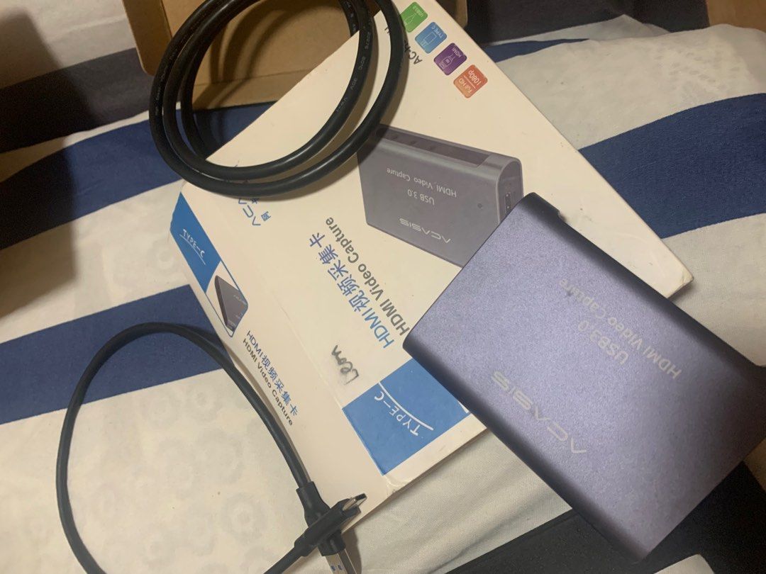 ACASIS USB 3.0 HDMI Video Capture Card (Category: Other Accessories) located in Manila. Submitted by adriatico-1128 (Listing ID 1408513538, Image 1). Description: ACASIS USB 3.0 HDMI Video Capture Card. It comes with a USB cable and a Type-C cable. The box is included. It is designed for capturing HDMI video. The model is USB 3.0. The color of the capture card is a dark grey/purple..