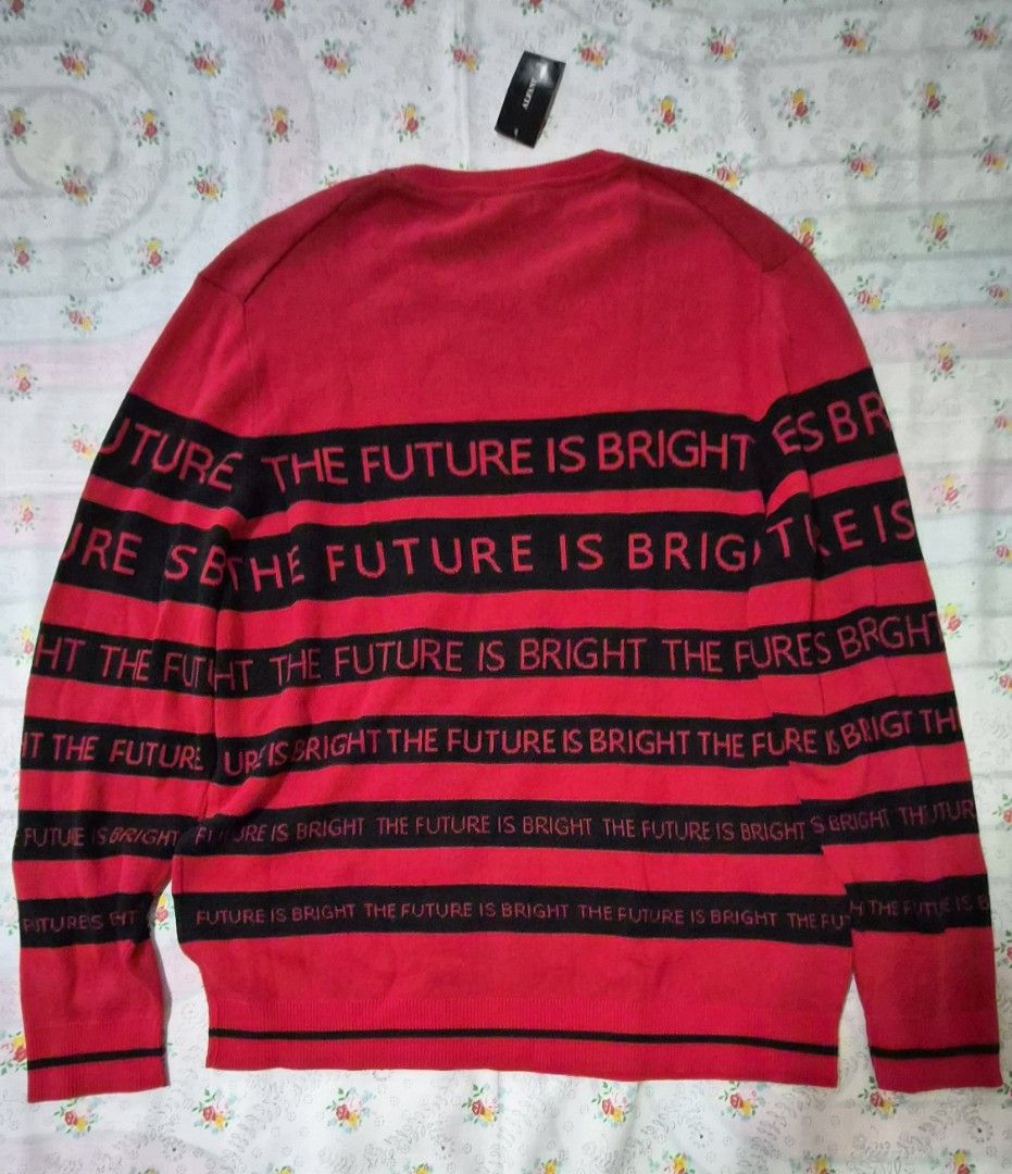 Alfani The Future is Bright Sweater XXL (Category: Coats, Jackets and Outerwear) located in Muntinlupa City. Submitted by atol0987 (Listing ID 1408564016, Image 3). Description: - Brand: Alfani - Size: XXL - Design: Red sweater with black stripes and "THE FUTURE IS BRIGHT" text - Features: Crew neck, long sleeves - Condition: New with tags.