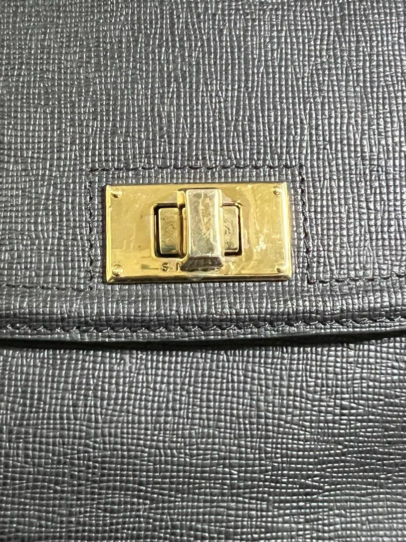 Sisley Satchel Handbag with Shoulder Strap (Category: Shoulder Bags) located in Manila. Submitted by Shib_Shoppe (Listing ID 1408612555, Image 2). Description: - Black satchel handbag - Top handle and detachable shoulder strap - Flap closure with gold-tone clasp - Interior zippered pocket - Exterior zippered pocket - Interior lining with repeating logo pattern - Gold-tone hardware - Preloved: Used but not abused - Minor scratches - check photos.