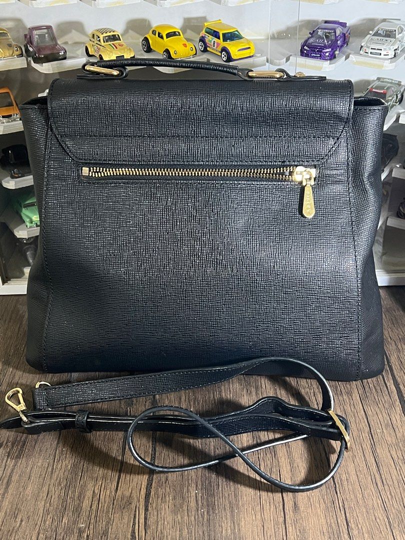 Sisley Satchel Handbag with Shoulder Strap (Category: Shoulder Bags) located in Manila. Submitted by Shib_Shoppe (Listing ID 1408612555, Image 3). Description: - Black satchel handbag - Top handle and detachable shoulder strap - Flap closure with gold-tone clasp - Interior zippered pocket - Exterior zippered pocket - Interior lining with repeating logo pattern - Gold-tone hardware - Preloved: Used but not abused - Minor scratches - check photos.