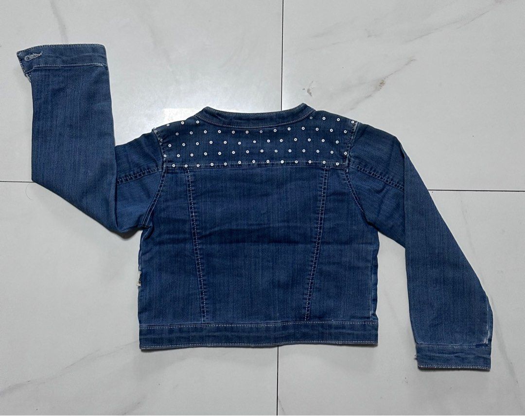 Boboli Denim Jacket with Sequins (Category: Babies & Kids Fashion) located in Manila. Submitted by chamwel (Listing ID 1408526588, Image 2). Description: - Boboli denim jacket - Classic design - Button-down front - Two chest pockets - Long sleeves - Sequin detail on shoulders - Perfect for layering.