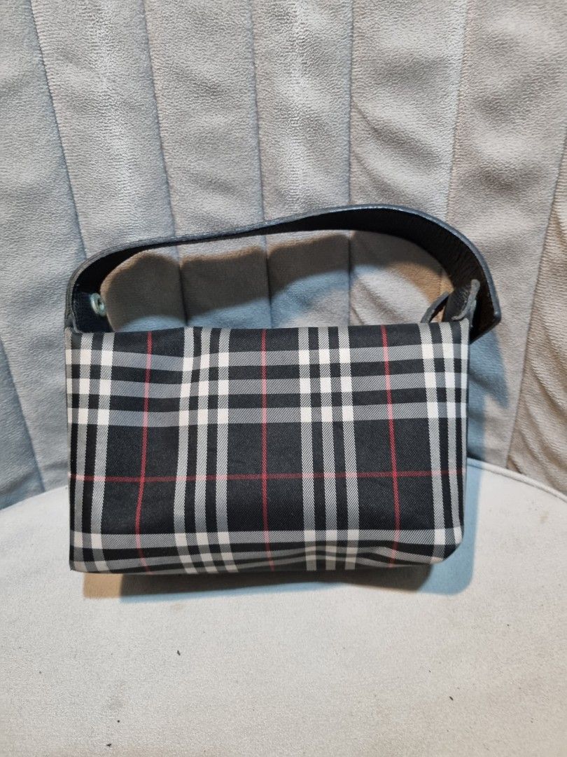 Burberry Mini Handbag (Category: Luxury Bags & Wallets) located in Batangas. Submitted by thevanitychamber (Listing ID 1408621454, Image 2). Description: - Authentic Burberry mini handbag - Classic Burberry check pattern (black, white, red) - Black handle and zipper closure - Includes dust bag - Features Burberry interior label - Compact size, ideal for essentials - A fashionable accessory.